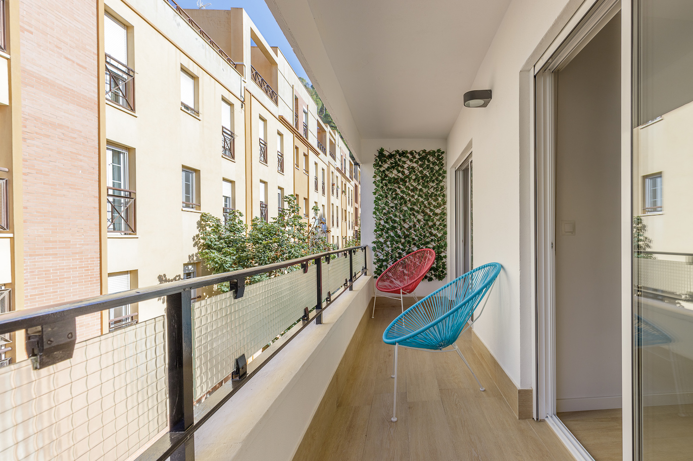 Cozy Balcony with Two Chairs Facing Small Street in Malaga Apartment