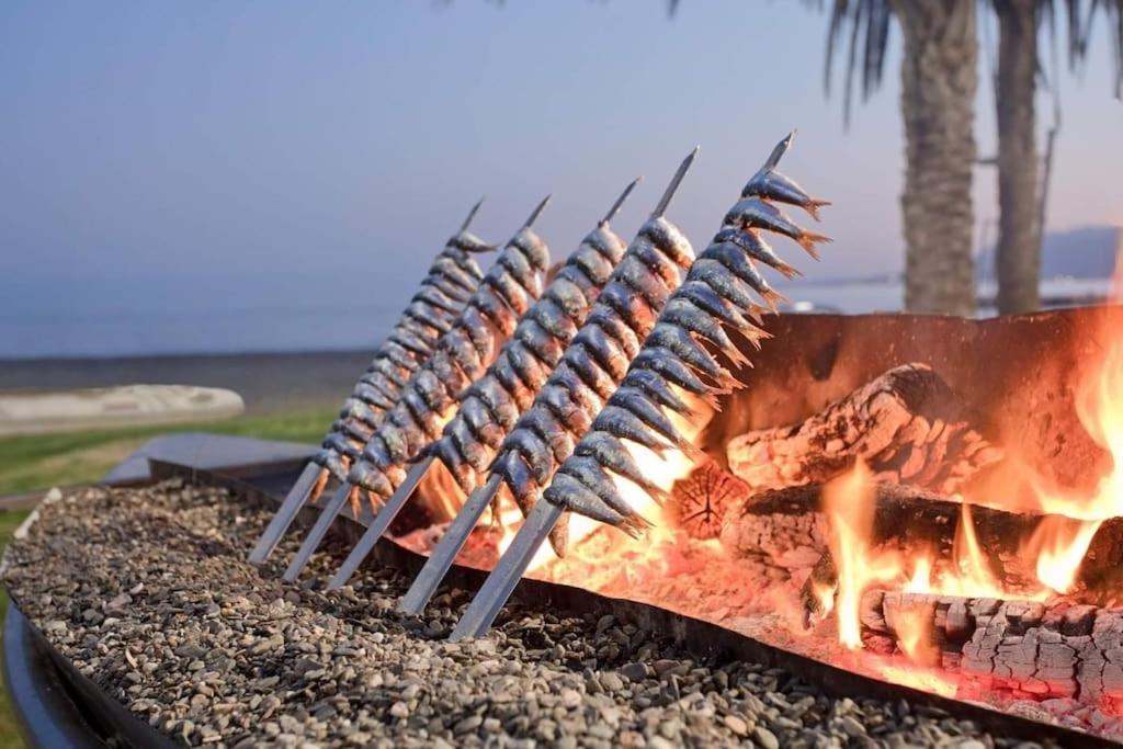 Espetos grilling at a beach chiringuito in Pedregalejo, Malaga